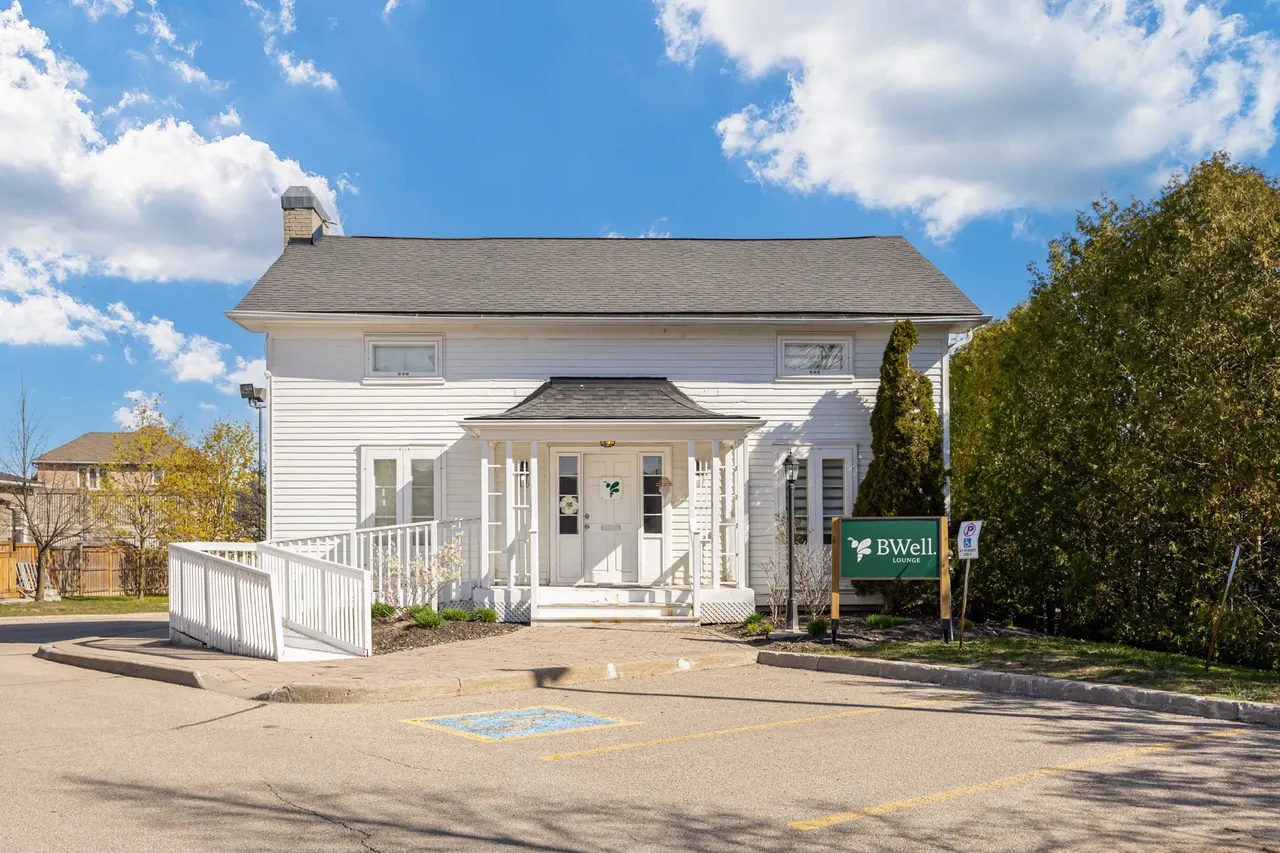 The BWell Lounge house at 75 Dawson Manor Blvd, Newmarket: a white two-storey house with a covered porch and a ramp