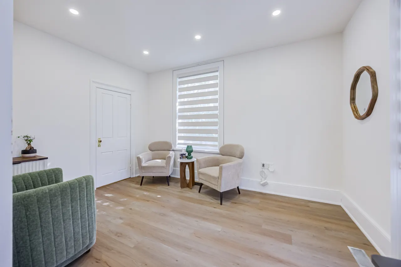 A seating nook with two cream chairs by a window